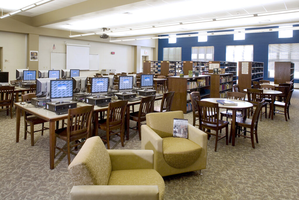 middle school media center with soft seating and computers